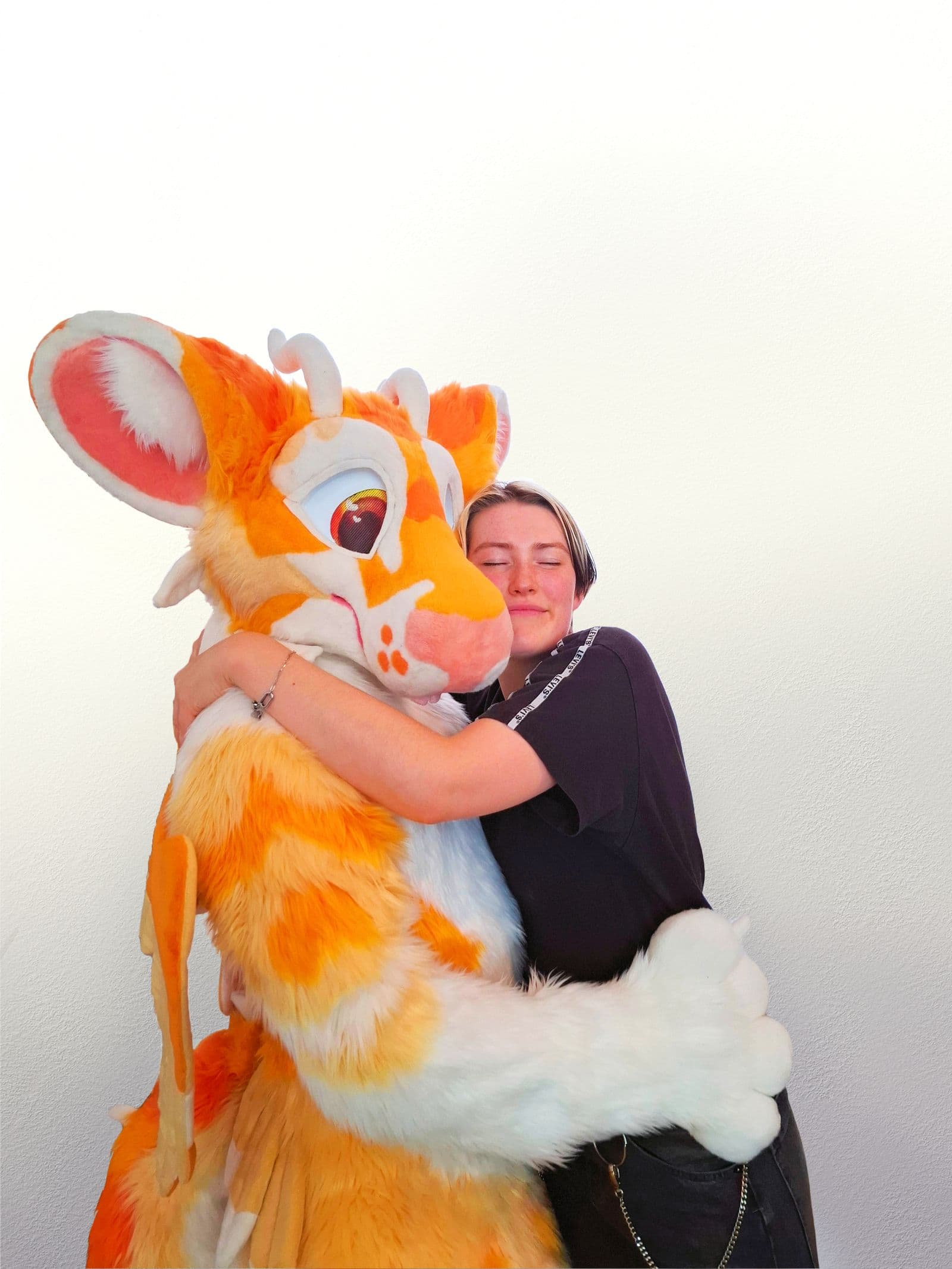 Chilli hugging one of the fursuits she made